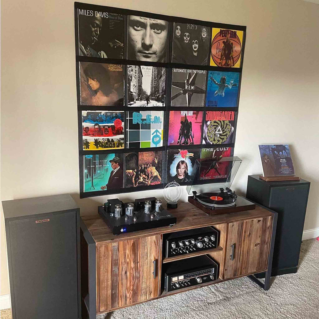Record Roots frames displaying a collection above a home hi-fi setup