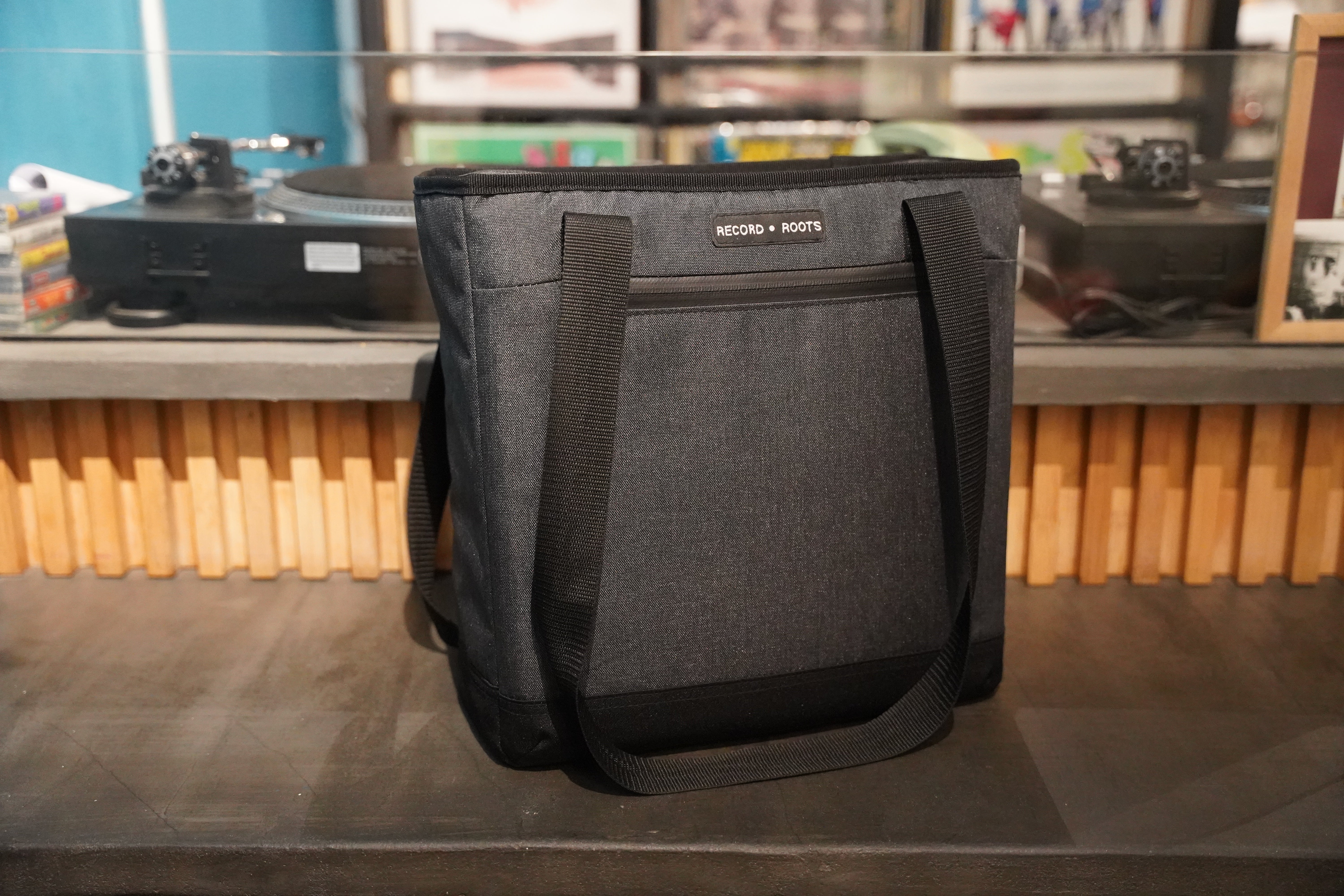 Record Roots tote bag beside turntables and vinyl records
